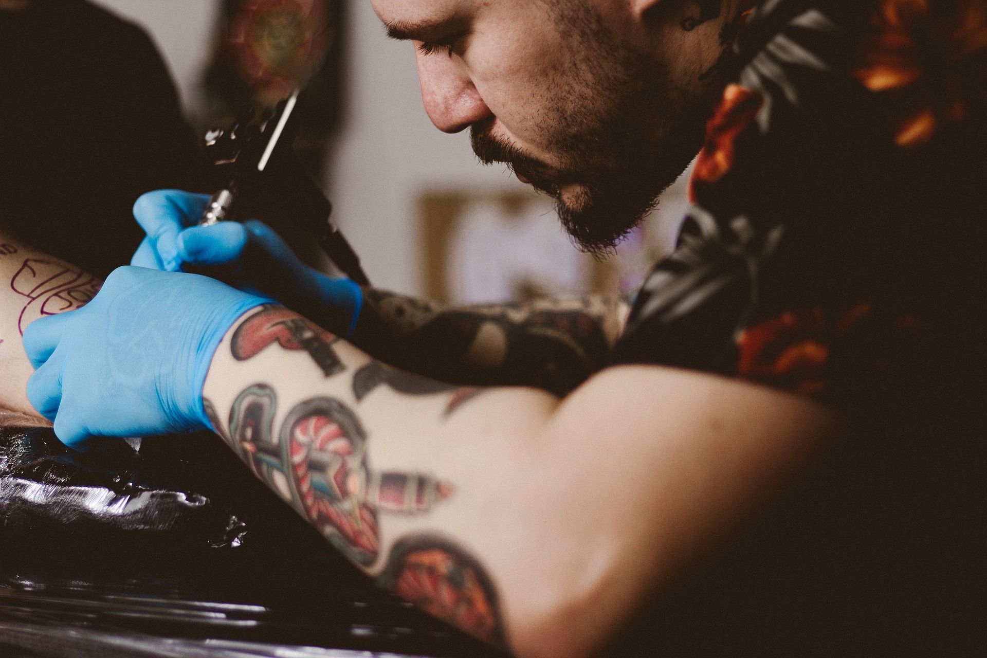 tatuador trabalhando na tatuagem de um cliente